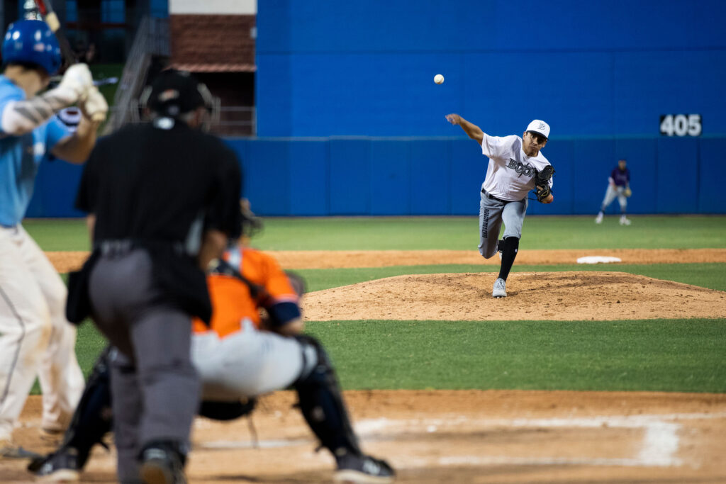 baseball pitcher throwing a baseball at a batter