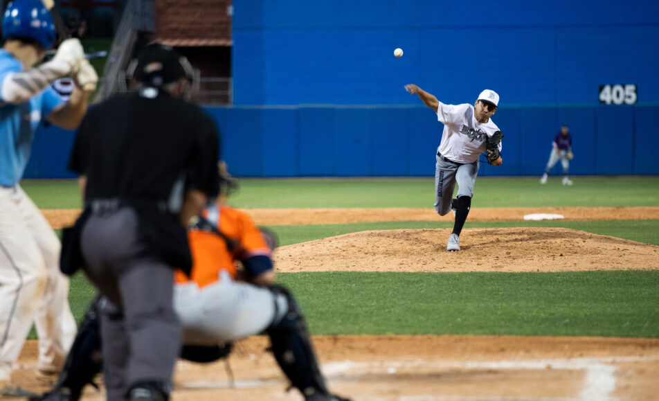 baseball pitcher throwing a baseball at a batter