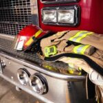 Firetruck closeup and firefighter jacket and helmet