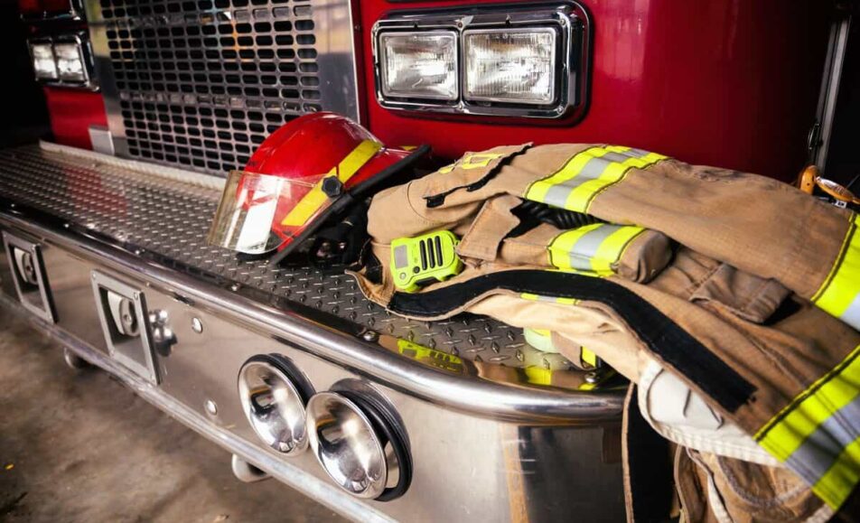 Firetruck closeup and firefighter jacket and helmet